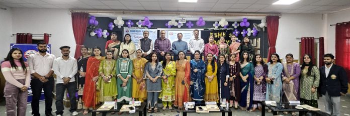 Dignitaries, teaching faculty and students posing during a programme.