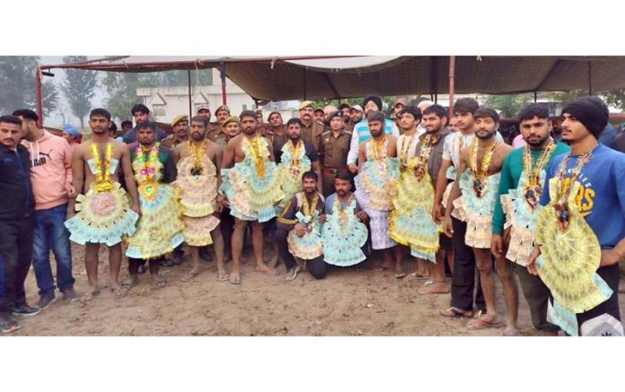 Dignitaries posing along with wrestlers during a Dangal event at Samba.