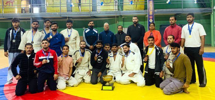 Judo team posing along with trophy at Jammu University.