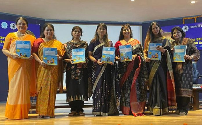 Dignitaries posing along with pamphlets during an event at Delhi.