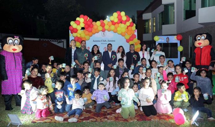 Dignitaries posing along with joyful kids during Bal Mela at Jammu Club.