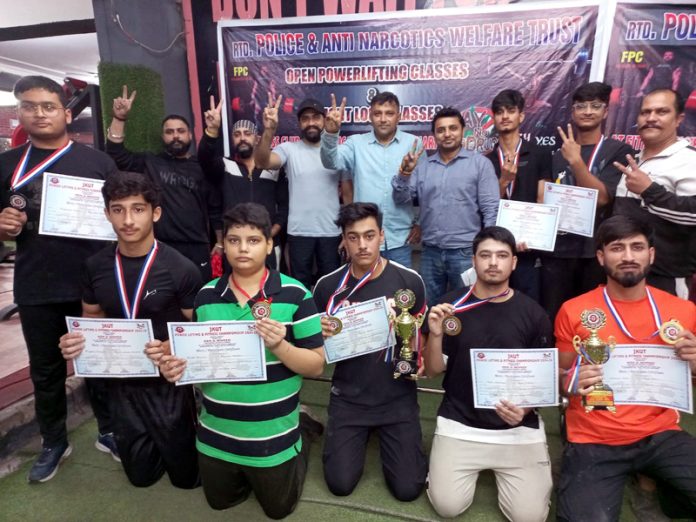 Powerlifters diaplaying medals & certificates at Jammu.