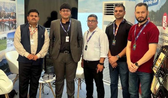 Director Information, J&K, Jatin Kishore posing along with staff members at J&K pavilion in Goa.