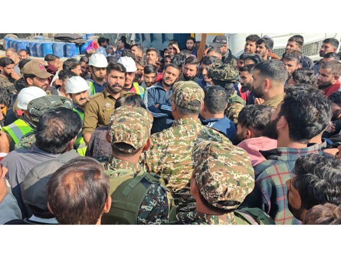 Assistant Labour Commissioner, Amit Kumar during talks with the agitating workers in Ramban on Tuesday.