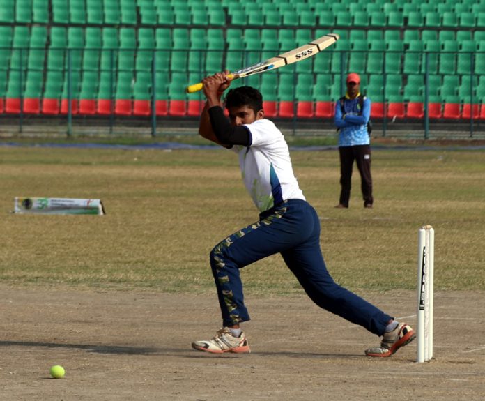 A player hits a shot during National Tennis Ball Cricket C’ship in Jammu. — Excelsior/Rakesh