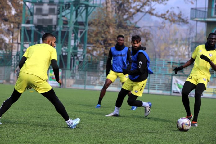 Football players in action during practice session at Srinagar.