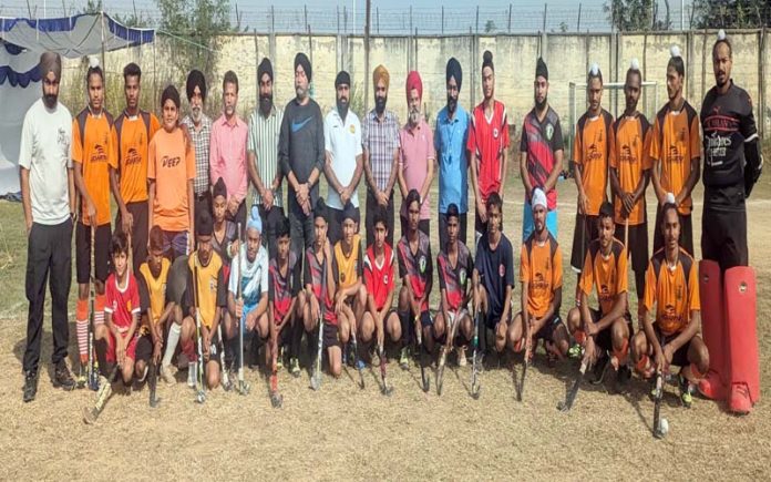 Dignitaries posing along with Hockey players at Jammu on Saturday.