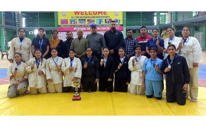 Judo players posing along with dignitaries during an event at Jammu University.