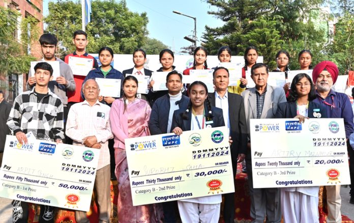 Dignitaries from NHPC and students who participated in painting competition organised in Jammu on Tuesday.