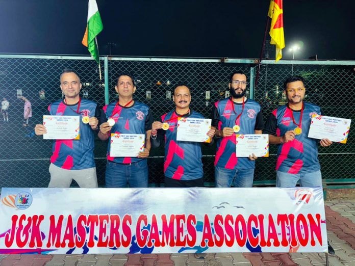 Players of Roller Skating Club Jindrah team pose for a photograph after lifting J&K Master Games title.