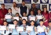 Students of Humanity Public School display certificates they won in an event organised at Alexander Memorial School in Jammu.