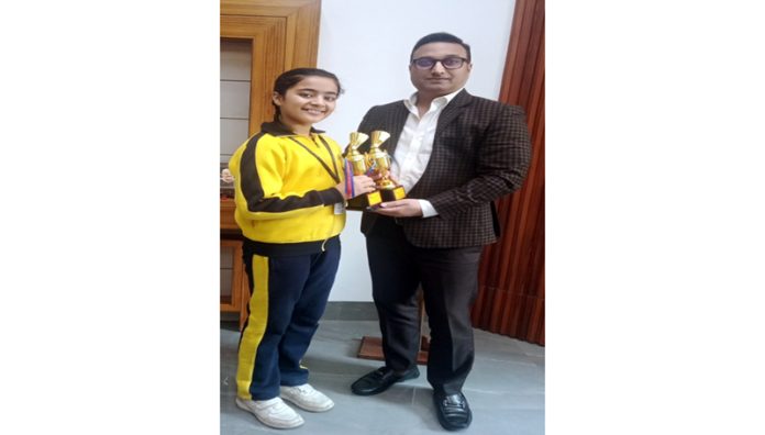 Akshini Manhas poses with trophies she won in 51st J&K UT Badminton championship.