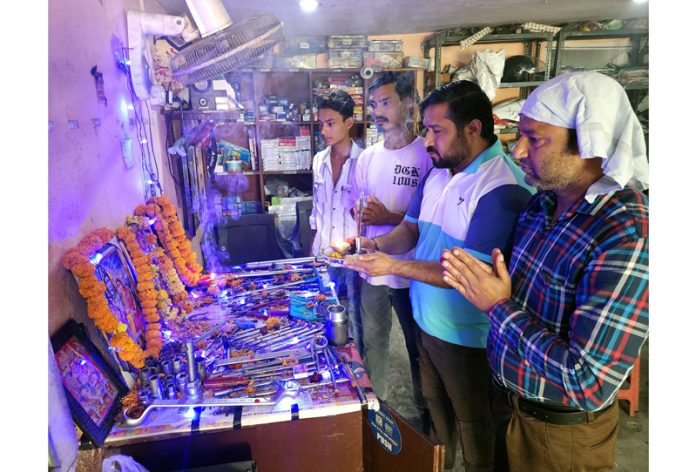 Workers in a workshop performing rituals to celebrate Vishwakarma Day at Jammu on Saturday. -Excelsior/Rakesh