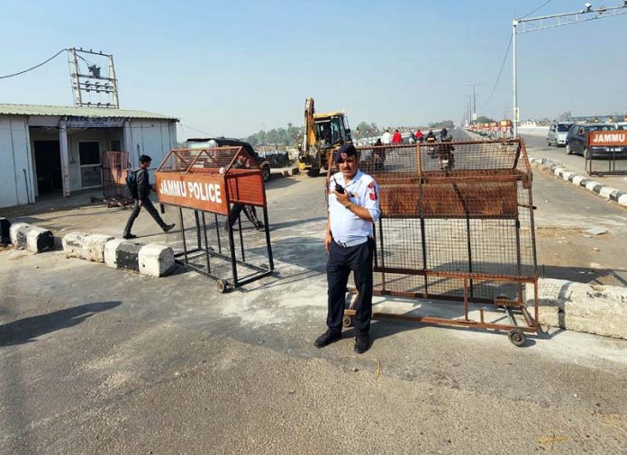 A traffic cop on the fourth bridge imposing the ban on heavy vehicles. -Excelsior Rakesh