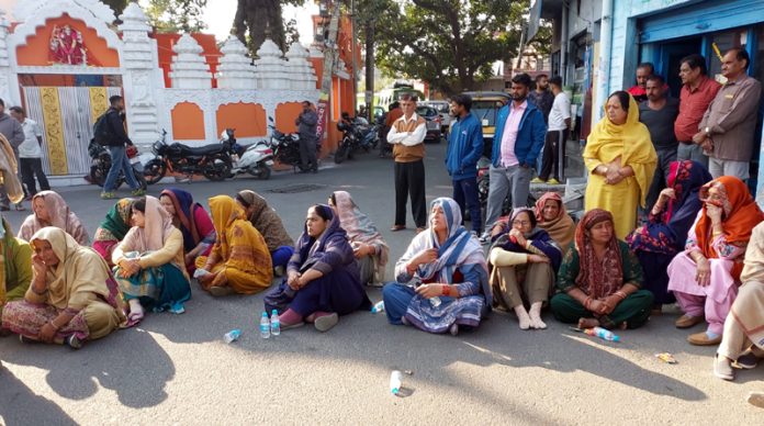 People staging protest over mysterious death of a woman, at Paloura Chowk, Jammu.