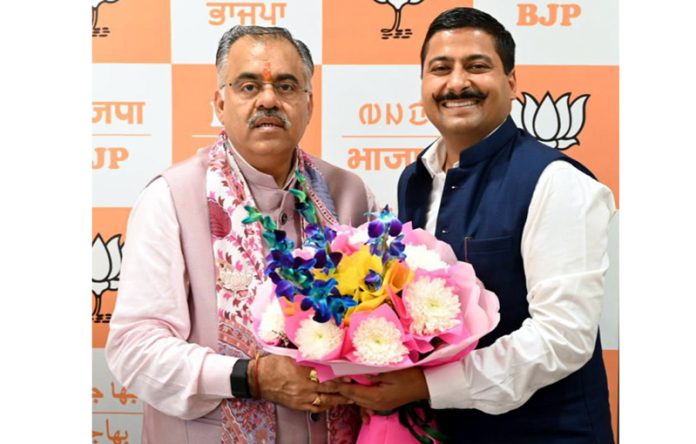 J&K BJP leader Gaurav Gupta with Party's National general secretary Tarun Chugh at New Delhi.