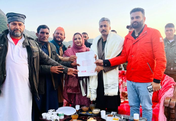 MLA Budhal, Javed Iqbal Choudhary receiving memorandum from locals at Rajnagar village on Sunday.