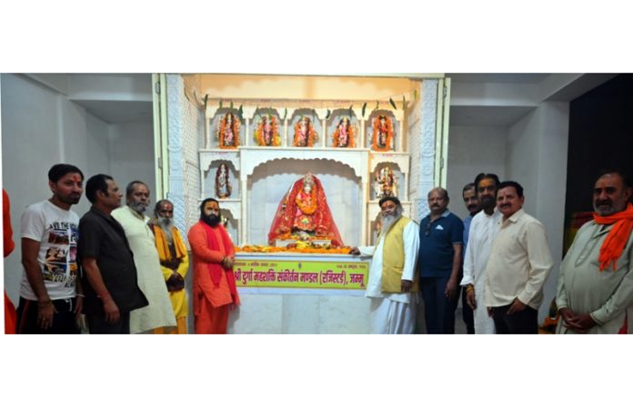 Mahant Rameshwar Das Maharaj posing along with others during the Prana-Pratishtha ceremony held at Thakurdwara Temple on Sunday.