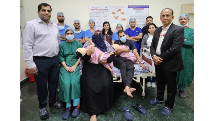 A team of doctors posing with Dr Yashpal Sharma (ED, SMVD Institute of Medical Excellence) after performing cochlear implant surgeries on two children.