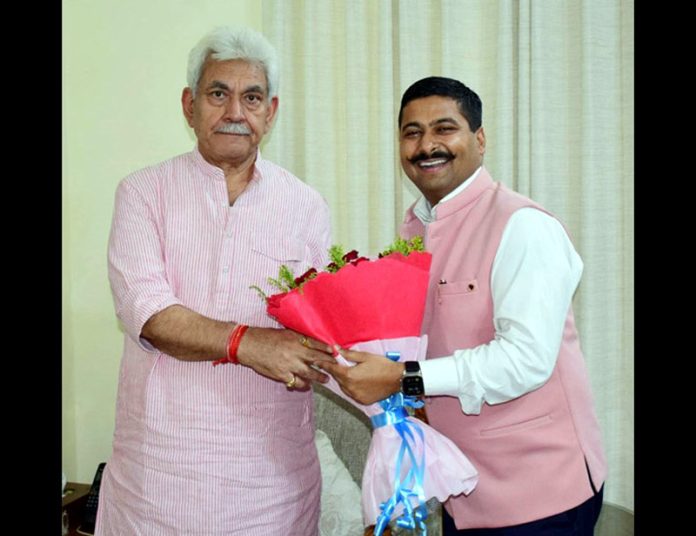 Former general secretary of CCI Jammu, Gaurav Gupta presenting a bouquet to LG Manoj Sinha.