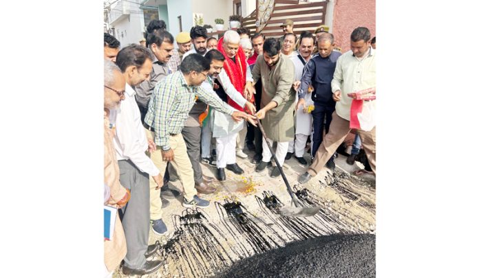 MLA Jammu North and former Minister, Sham Lal Sharma kick starting macadamization of road in Ward 64.