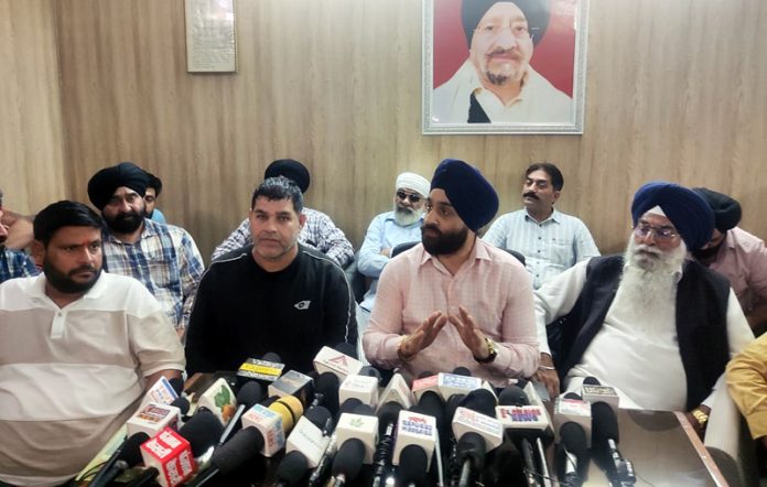 Karan Singh Wazir, Chairman of AJKTWA addressing a press conference in Jammu on Tuesday.