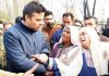 DC Srinagar meeting victims of fire incident.