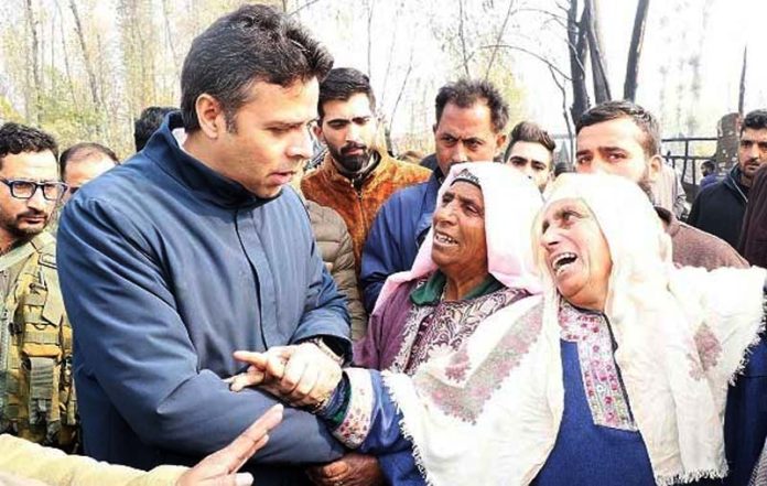 DC Srinagar meeting victims of fire incident.