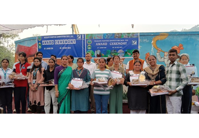 Students with the chief guest and others.