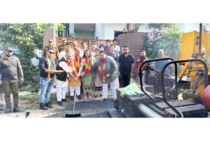 BJP MLAs Vikram Randhawa and Dr D K Manyal kick starting blacktopping work in Channi Himmat on Sunday.