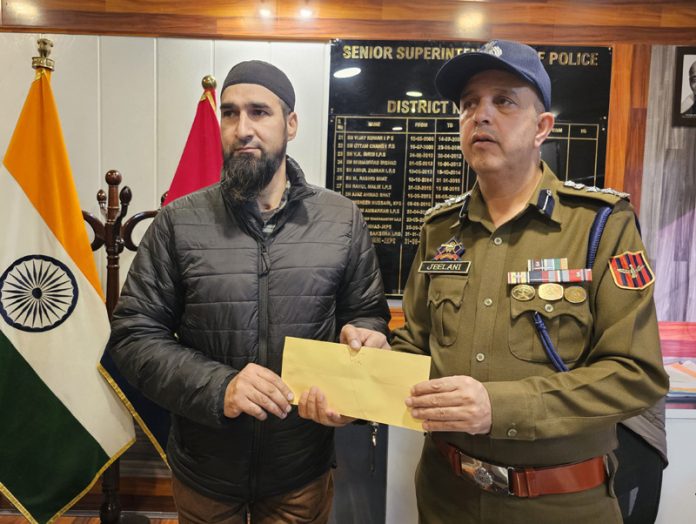 SSP Kupwara, Ghulam Jeelani Wani, presenting a cash reward to a police officer on Tuesday.