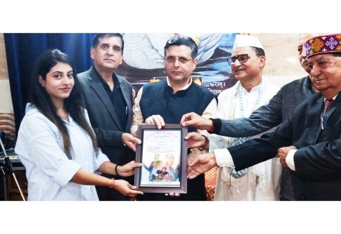 Dignitaries awarding a young artist during release of short film Daghh at Jammu on Sunday.