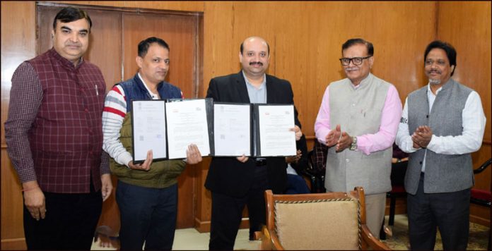 SMVDU Registrar and TSL Chief Sales Manager displaying copies of MoU signed by them.