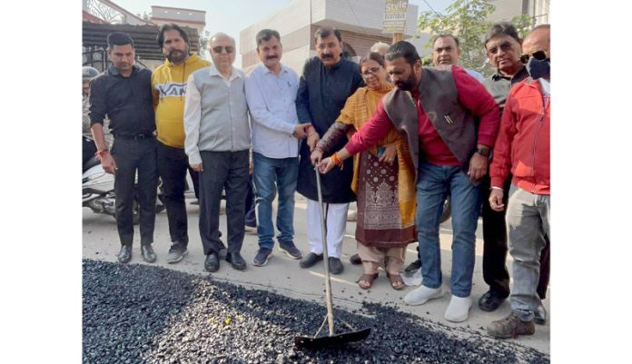 MLA Arvind Gupta kick-starting blacktopping work of road in Kabir Colony on Thursday.