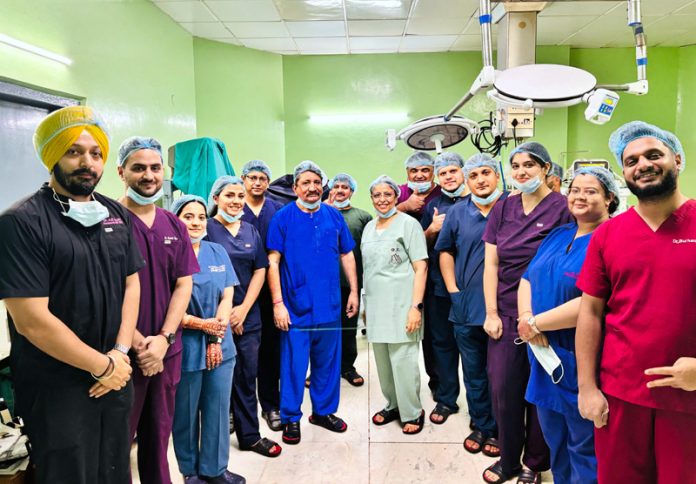 A team of doctors posing together after performing a complex surgery at ASCOMS Jammu.