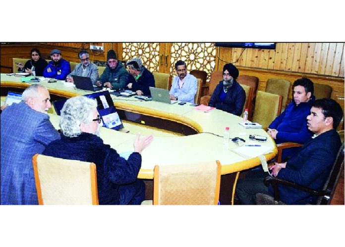 Div Com Kashmir chairing a meeting on Friday.