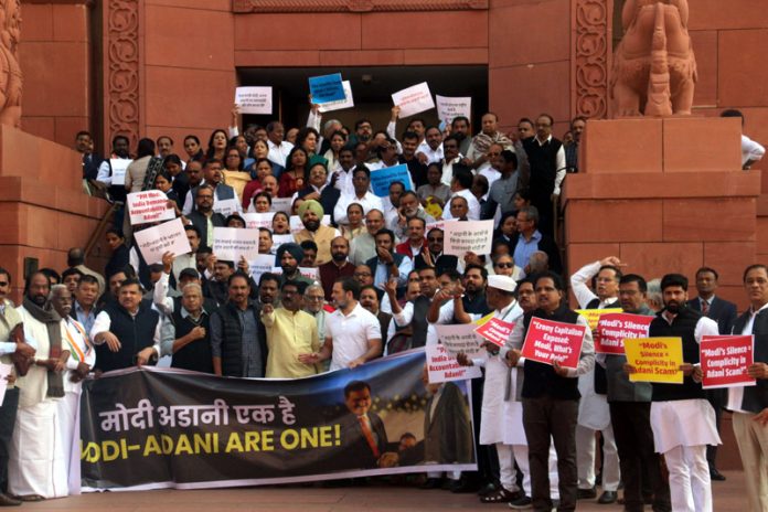 Opposition MPs stage protest over Adani issue outside the Parliament House on Tuesday. (UNI)