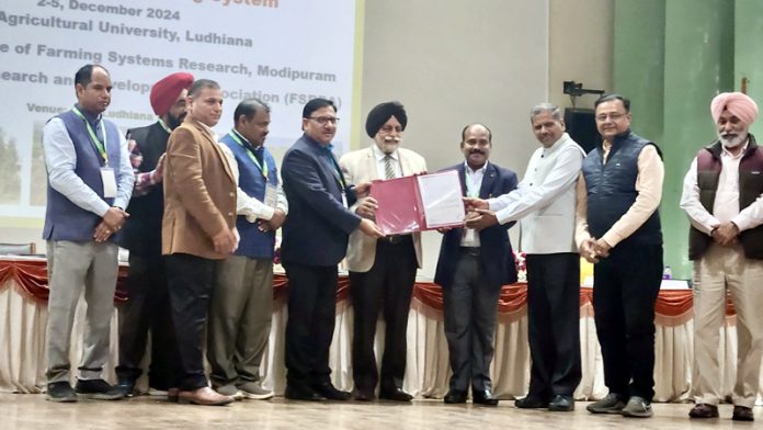 Dignitaries present OFR (SCSP) award to FSR Centre of SKUAST-J during a workshop in Ludhiana.