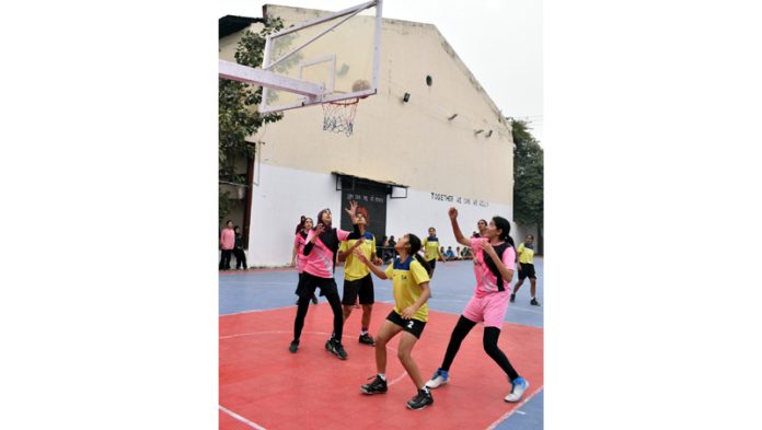 Basketball players in action during a match at MA Stadium Jammu.