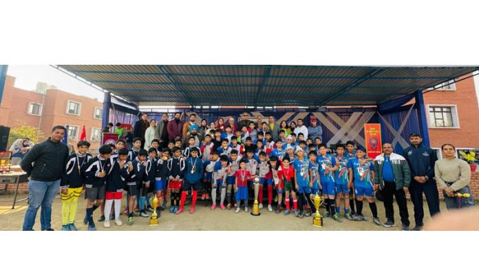 Players posing along with trophies during prize distribution ceremony of Doon International School.