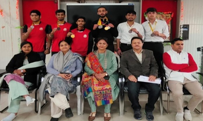 Students of GDC Kunjwani who won medals in different Inter-College tournaments pose for a photograph with College staff.