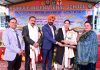 Management presenting memento to dignitary during a programme.