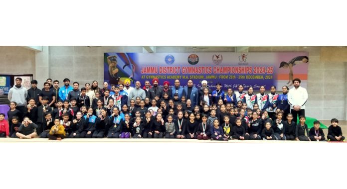 Gymnasts posing along with dignitaries during District Jammu Gymnastics Championships at MA Stadium, Jammu.