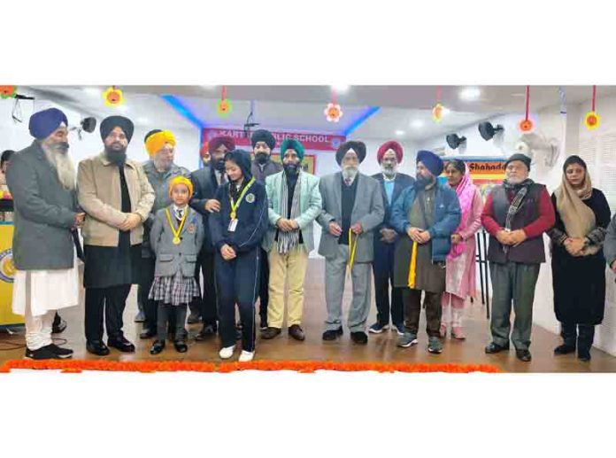 Poets and others posing for a group photograph during Punjabi Kavi Durbar at a school in Kathua on Saturday.