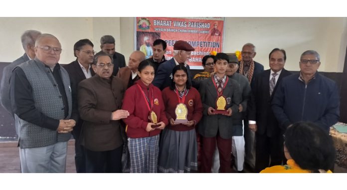 Students posing along with trophies during a speech competition at Jammu.