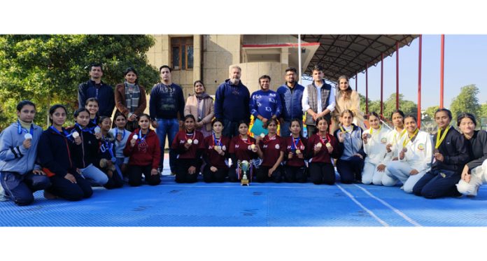 Medal winners posing along with dignitaries during Inter-Collegiate Yoga Championship at Jammu University.