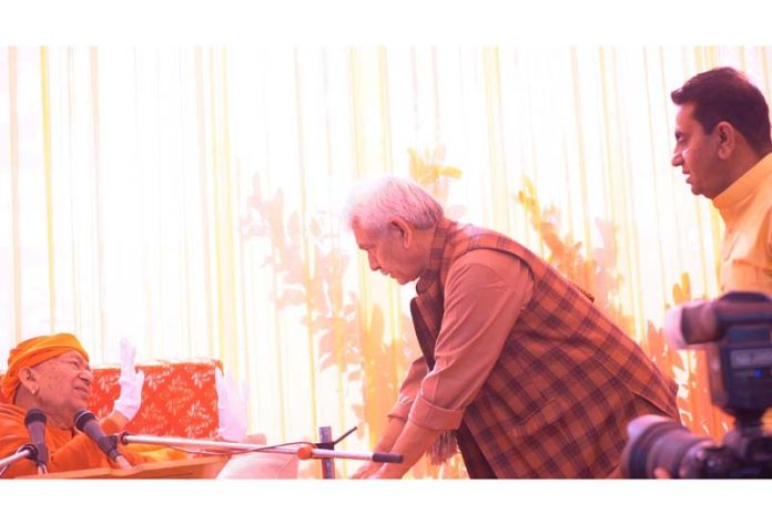 LG Manoj Sinha seeking blessings of Swami Ram Swarup Yogacharya at the residence of MLA Rajiv Jasrotia in Kathua district on Sunday.