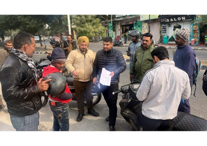 A team from RTO Jammu scrutinising the documents of a biker in Jammu on Wednesday.