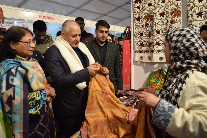 Minister Javid Dar inspecting a stall at an exhibition.