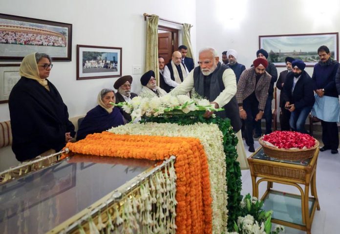 Prime Minister Narendra Modi pay tribute to former Prime Minister Manmohan Singh in New Delhi on Friday. (UNI)